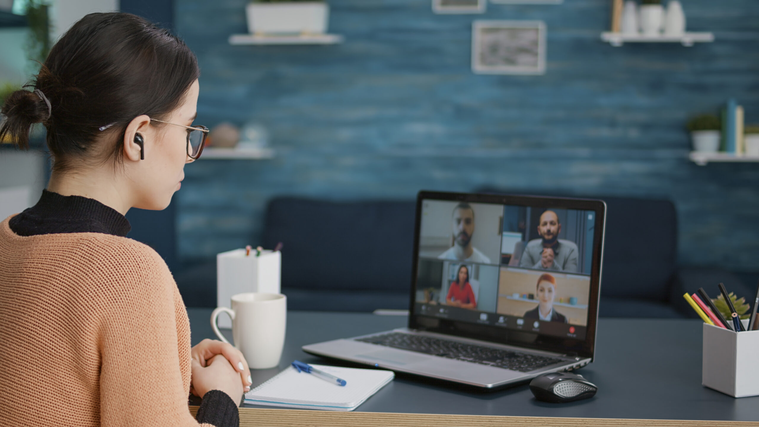 University student attending video call meeting with people